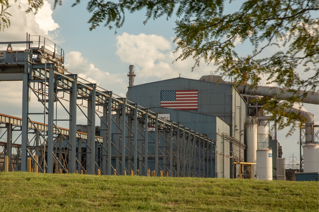 Photo of Nucor steel mill with an American flag on the face of the building