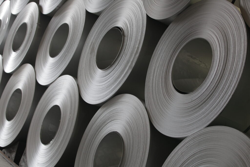 Photo of flat-rolled steel coils stacked on top of one another.