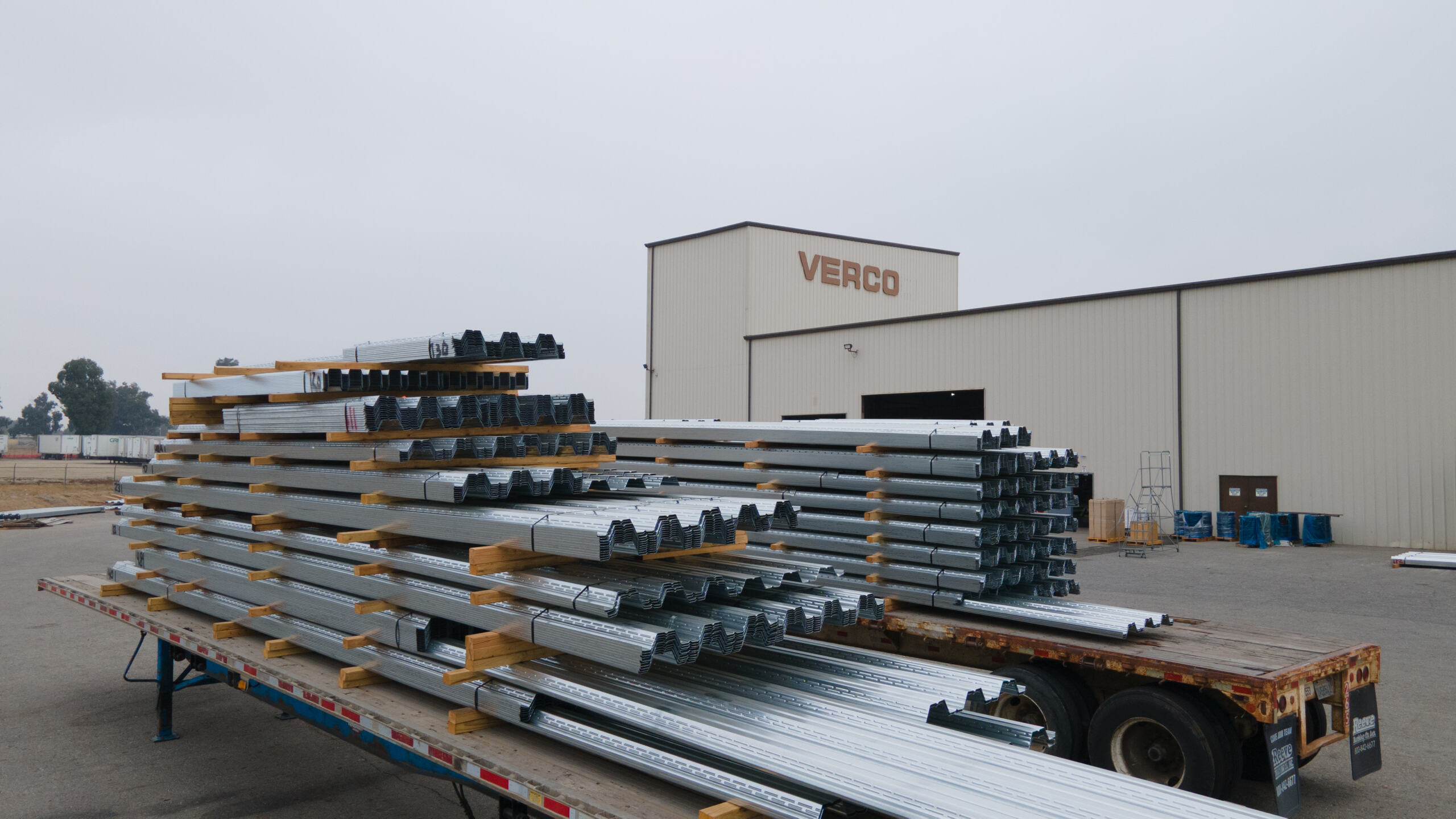 photo of the outside of a Verco building with a truck full of verco steel in front of it